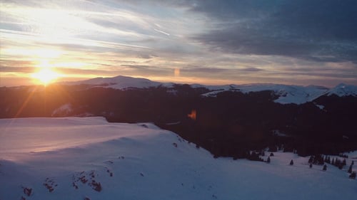 Golden Sunrise over Majestic Snow-Capped Mountains