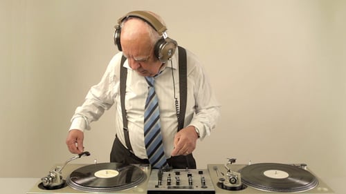 Senior Man Wearing Headphones Playing Music