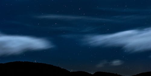 Stars Moving In Night Sky Over Mountain Ridge