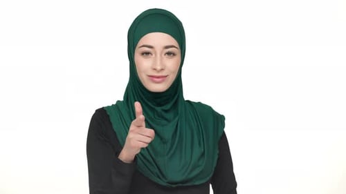 Woman in Green Hijab Points and Waves