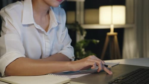 Woman Works on Laptop Late at Night