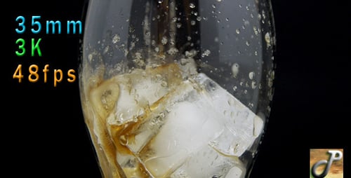 Soda Being Poured into Glass with Ice