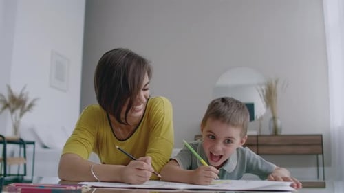 Woman and Child Drawing Together at Home