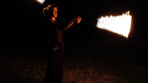 Woman Performs Fire Dancing at Night