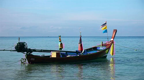 Ornate Wooden Boat on Turquoise Tropical Sea