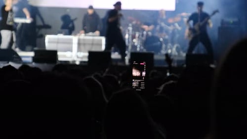 People at the Rock Concert Broadcast Live on Social Networks Using a Smartphone