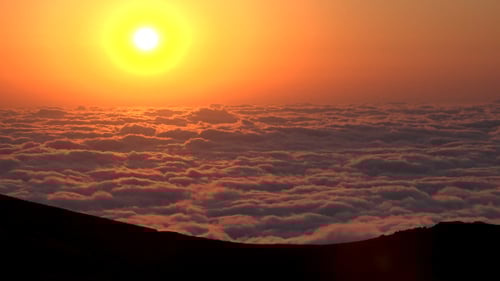 Majestic Sunrise Above Clouds in the Mountains