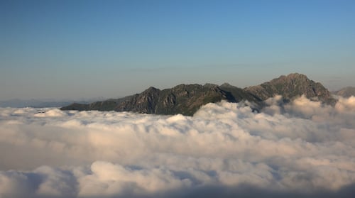 Mountains Rising Above Cloudscape in Golden Light