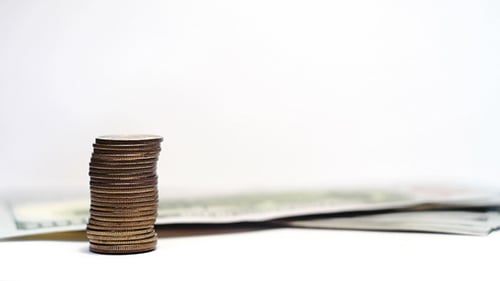 Stacks of Coins Increasing on White Background