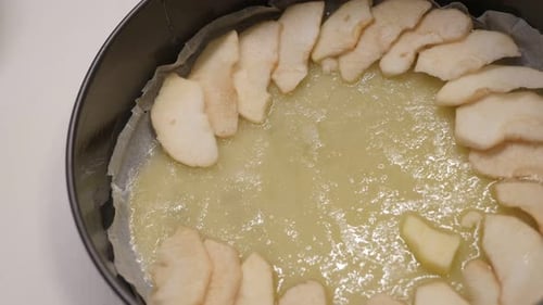 Tasty apple pie detailed preparation close-up 4K 2160p 30fps UltraHD footage - Fruit pieces in bakin