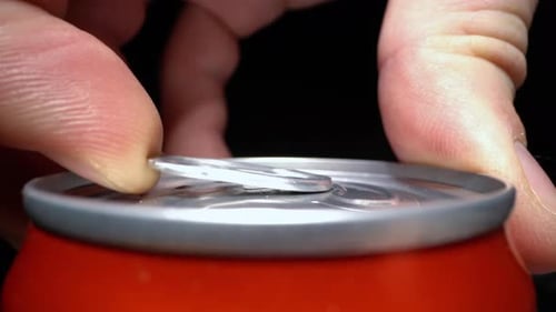 Man Opening Can with Beer or Lemonade Close Up