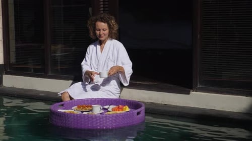 Woman Enjoys Breakfast in Private Pool at Villa