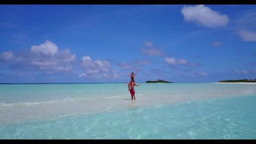 Family of two tan on paradise coast beach trip by aqua blue sea and clean sand background of the Mal