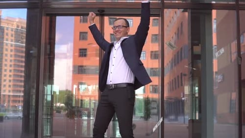 Rich Attractive Businessman in Glasses Picks Up Money and Rejoices