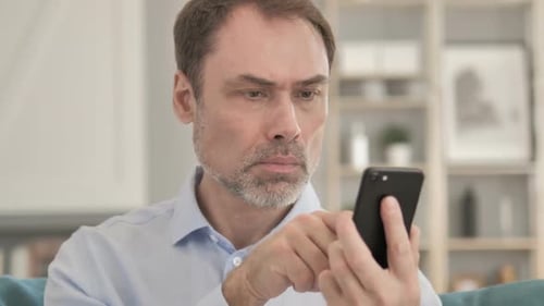 Man Using Smartphone in Bright Home Interior