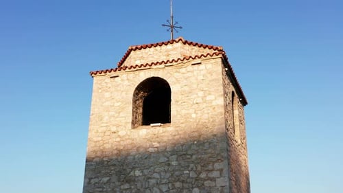 Old watchtower made of stone - tall medieval building. Observation deck - viewing platform