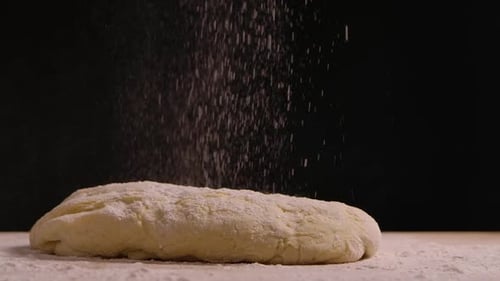 Sprinkle Flour on the Dough Lying on the Kitchen Table