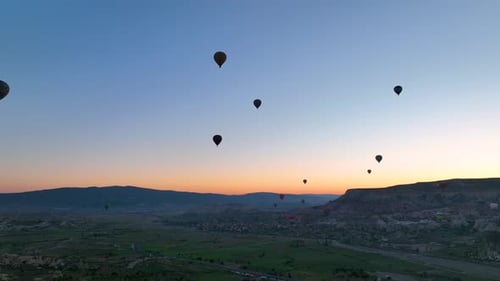 4K Aerial view of Goreme. Colorful hot air balloons fly over the valleys.