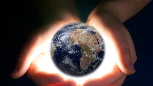 Hands Holding Glowing Earth Globe