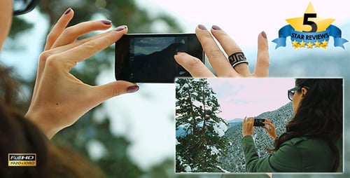 Woman Taking Photo of Winter Mountain Landscape