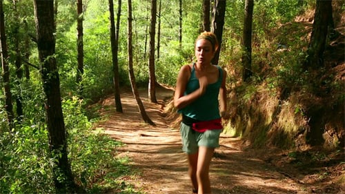 Woman Running on a Forest Trail