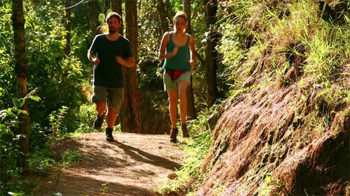 Couple Running Along Narrow Footpath