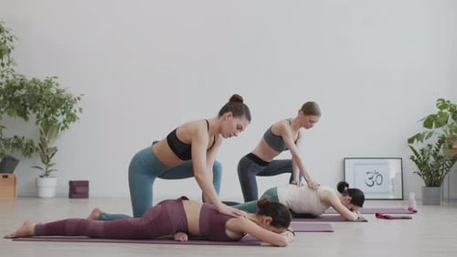 Yoga Practice: Women Stretching in Bright Studio