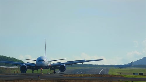 Commercial Airplane on Runway in Tropical Location