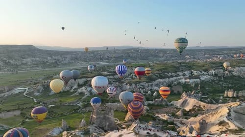 4K Aerial view of Goreme. Colorful hot air balloons fly over the valleys.