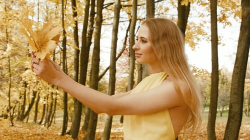 Young Woman Walking In The Autumn City Park