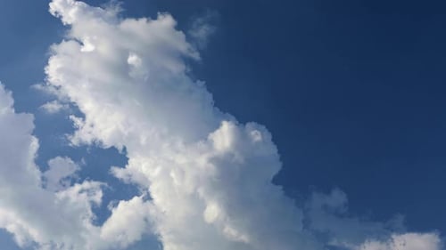 4k time Lapse of very white clouds moving in interesting way against a stark blue sky background. Ve