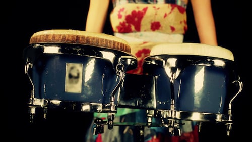 Woman Playing Bongos in a Close Up Shot