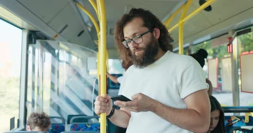 Man Using Smartphone Riding City Bus
