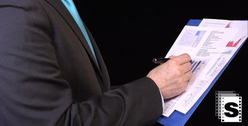 Close Up of Man in Suit Analyzing Charts