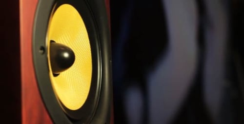 Vibrant Yellow Speaker Cone Vibrating to Sound