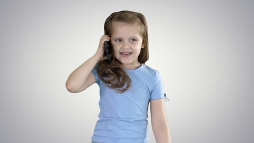 Smiling Girl Talks on Smartphone Device