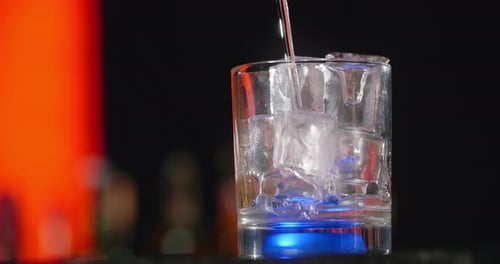 Cocktail Being Poured into Glass of Ice