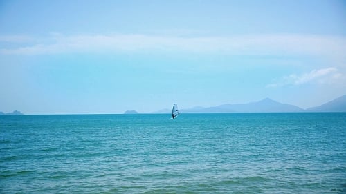 Windsurfing on a Clear Day in a Blue Sea