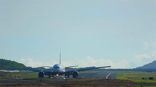 Jumbo Jet Airplane Landing on Tropical Runway