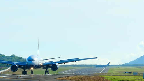 Airplane Landing on Runway During the Day