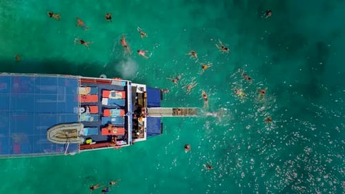 Aerial view of people in ferry diving on the sea, Ithaki island, Greece.