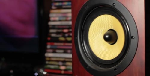 Speaker Pumping with Stack of DVDs in Background