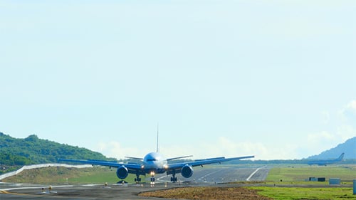 Airplane Landing on Tropical Island Runway