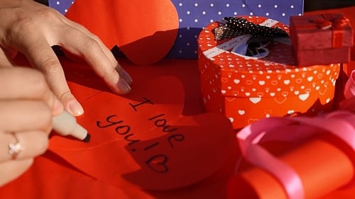 Writing 'I Love You' Message on Red Heart