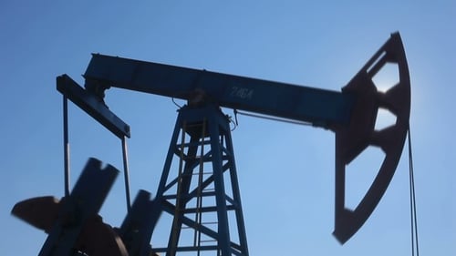 Oil Pump Jack Working with Sun Flare