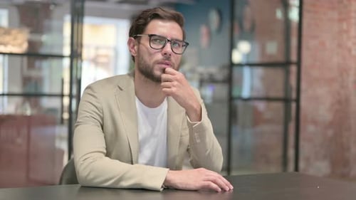 Pensive Young Man Sitting Thinking