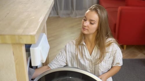 Young Woman Doing Laundry at Home