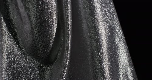 Shimmering Dark Material Flowing Abstractly