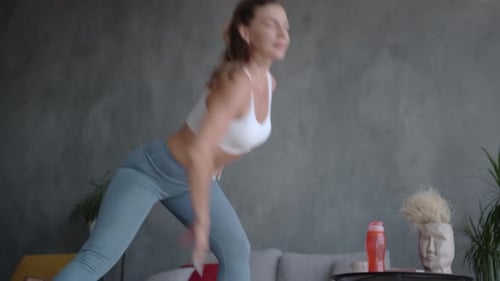 Woman Does Stretching Exercises in a Bright Home