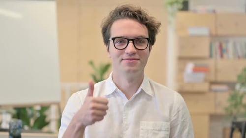 Young Adult Gives Thumbs Up in Office